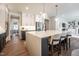 Bright kitchen features a large island with seating, stainless appliances, and stylish pendant lighting at 306 White Magnolia Ln, Fuquay Varina, NC 27526