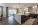 Open kitchen features stainless steel appliances, quartz counters, and convenient access to the patio at 306 White Magnolia Ln, Fuquay Varina, NC 27526