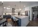 Bright kitchen features quartz counters, two-tone cabinets, stainless steel appliances, and pendant lighting at 306 White Magnolia Ln, Fuquay Varina, NC 27526