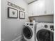 The well-lit laundry room is equipped with modern washer and dryer units and tasteful decor at 306 White Magnolia Ln, Fuquay Varina, NC 27526