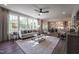Bright, open-concept living room with large windows, stylish furniture, and seamless flow into the dining and kitchen areas at 306 White Magnolia Ln, Fuquay Varina, NC 27526