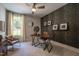 Office with decorative wallpaper accent wall, modern desk setup, and natural light from the window at 306 White Magnolia Ln, Fuquay Varina, NC 27526