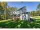 Back of the house features a screened in porch, wooden deck, and lush lawn at 306 White Magnolia Ln, Fuquay Varina, NC 27526