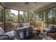 Relaxing Screened Porch featuring neutral color palette, comfortable seating and wooded view at 306 White Magnolia Ln, Fuquay Varina, NC 27526