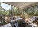 Relaxing Screened Porch featuring neutral color palette, comfortable seating and wooded view at 306 White Magnolia Ln, Fuquay Varina, NC 27526