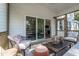 Screened porch features stylish furniture, fan, and access to the home's interior at 306 White Magnolia Ln, Fuquay Varina, NC 27526