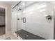 This glass-enclosed shower features black and white tiles and a shower head at 306 White Magnolia Ln, Fuquay Varina, NC 27526
