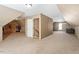 Large attic features carpet, a doorway, and natural light, offering potential as a flexible living area at 310 Cedarhurst Ln, Franklinton, NC 27525