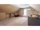 Finished attic space with carpet, modern lighting, a couch, and window with natural light at 310 Cedarhurst Ln, Franklinton, NC 27525