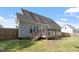 Back of the house with wooden deck and stairs to the fenced-in backyard at 310 Cedarhurst Ln, Franklinton, NC 27525