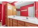 Bathroom featuring a double vanity, a framed mirror, and warm oak cabinetry at 310 Cedarhurst Ln, Franklinton, NC 27525