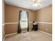 This bedroom features neutral carpet, a ceiling fan, and a window for natural light at 310 Cedarhurst Ln, Franklinton, NC 27525