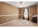 This bedroom features neutral carpet, a ceiling fan, and a window for natural light at 310 Cedarhurst Ln, Franklinton, NC 27525