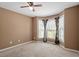 Bright bedroom featuring neutral carpet, bay windows, and a ceiling fan at 310 Cedarhurst Ln, Franklinton, NC 27525