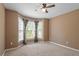 Bright bedroom featuring neutral carpet, bay windows, and a ceiling fan at 310 Cedarhurst Ln, Franklinton, NC 27525
