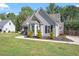 Gray home with an attached garage, bay window, and tidy front lawn at 310 Cedarhurst Ln, Franklinton, NC 27525