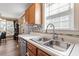 Bright kitchen features stainless steel sink, modern backsplash, and plenty of natural light from the window at 310 Cedarhurst Ln, Franklinton, NC 27525