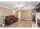 Inviting living room with hardwood floors, a cozy fireplace, and comfortable seating for relaxing and entertaining at 310 Cedarhurst Ln, Franklinton, NC 27525