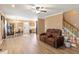 Cozy living room with hardwood floors, plush seating, and a staircase, ideal for relaxing and entertaining guests at 310 Cedarhurst Ln, Franklinton, NC 27525