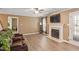 Spacious living room with fireplace, hardwood floors, and windows, perfect for comfortable living and entertaining at 310 Cedarhurst Ln, Franklinton, NC 27525