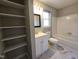 Clean bathroom featuring tile flooring, shelving, a new vanity, and new lighting at 3109 Cinnamon Circle Cir, Raleigh, NC 27610