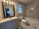 Bright bathroom featuring a toilet, bathtub, shower, vanity, and updated tile at 3109 Cinnamon Circle Cir, Raleigh, NC 27610