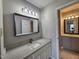 Well-lit bathroom with a granite vanity, modern mirror, and tiled floors at 3109 Cinnamon Circle Cir, Raleigh, NC 27610