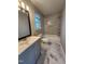 Renovated bathroom with marble tile, a soaking tub, and modern fixtures at 3109 Cinnamon Circle Cir, Raleigh, NC 27610
