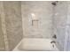 Close-up of a bathtub with marble tile surround and inset mosaic tile at 3109 Cinnamon Circle Cir, Raleigh, NC 27610