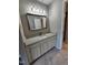Modern bathroom featuring granite countertops, updated fixtures, and a large mirror at 3109 Cinnamon Circle Cir, Raleigh, NC 27610
