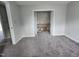 A cozy room with gray carpet flooring and a large closet offering extra storage at 3109 Cinnamon Circle Cir, Raleigh, NC 27610