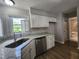 Bright kitchen featuring granite countertops, stainless steel appliances, and a view through the window at 3109 Cinnamon Circle Cir, Raleigh, NC 27610