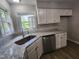 Well-lit kitchen featuring granite countertops, new stainless steel appliances, and white cabinetry at 3109 Cinnamon Circle Cir, Raleigh, NC 27610