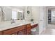 Well-lit bathroom with white vanity, solid surface counters, storage, and a serene view at 317 Okamato St, Raleigh, NC 27603