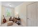 Cozy bedroom with natural light, featuring a guitar, leather chair, and wooden accent table at 317 Okamato St, Raleigh, NC 27603