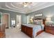 This primary bedroom has recessed ceilings, a ceiling fan, with windows offering a serene outdoor view at 317 Okamato St, Raleigh, NC 27603