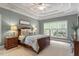 Inviting bedroom showcasing a tray ceiling, a ceiling fan and large bright windows at 317 Okamato St, Raleigh, NC 27603