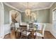 Elegant dining room featuring a modern chandelier and glass table with seating for four at 317 Okamato St, Raleigh, NC 27603