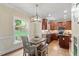 Bright eat-in kitchen featuring hardwood floors, a view to the backyard, and an island at 317 Okamato St, Raleigh, NC 27603