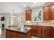 Open kitchen featuring an island, stainless appliances, granite countertops, and a breakfast nook at 317 Okamato St, Raleigh, NC 27603