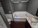 A bathroom suite with a relaxing garden tub, a convenient toilet, and elegant dark wood cabinetry at 323 Coral Ave, Goldston, NC 27252
