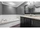 A bathroom suite with a luxurious garden tub, granite countertops, and modern fixtures for comfortable living at 323 Coral Ave, Goldston, NC 27252
