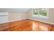 A bright bedroom with hardwood floors and a large window allowing for an abundance of natural light at 323 Coral Ave, Goldston, NC 27252