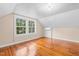 Attic bedroom features hardwood floors, crisp white trim, and lots of natural light at 323 Coral Ave, Goldston, NC 27252