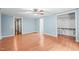 A bright bedroom features a ceiling fan, hardwood floors, and a walk-in closet and attached bathroom at 323 Coral Ave, Goldston, NC 27252