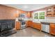 Kitchen with stainless steel appliances, granite counters, wooden cabinets, and a farmhouse sink at 323 Coral Ave, Goldston, NC 27252
