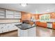 Rustic kitchen features granite counters, stainless steel appliances, and a farmhouse sink at 323 Coral Ave, Goldston, NC 27252