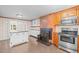 Kitchen with brick accents, granite island, wood cabinets, and stainless steel appliances at 323 Coral Ave, Goldston, NC 27252