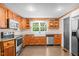 Bright kitchen with stainless steel appliances, granite countertops, and natural wood cabinetry at 323 Coral Ave, Goldston, NC 27252