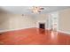 Living room with fireplace and hardwood floors offering a view into another room at 323 Coral Ave, Goldston, NC 27252